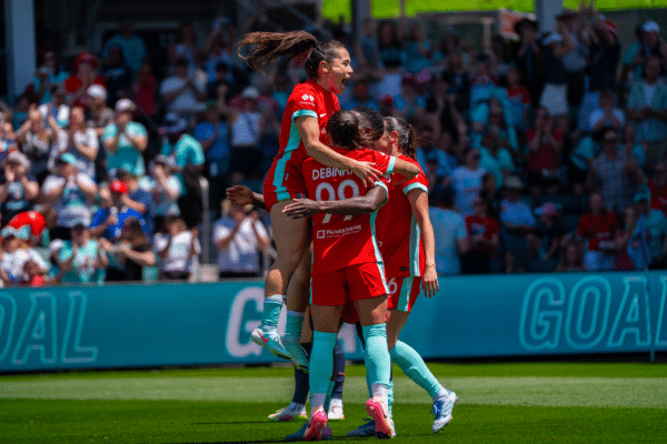Lo, Temwa, and Debinha are celebrating.