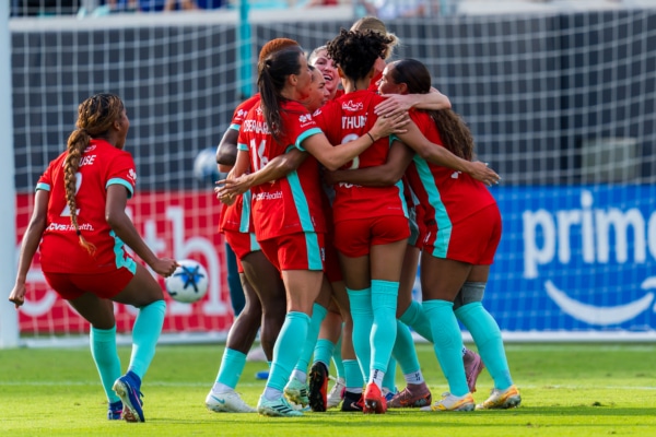 Team celebrating goal vs Washington Spirit.