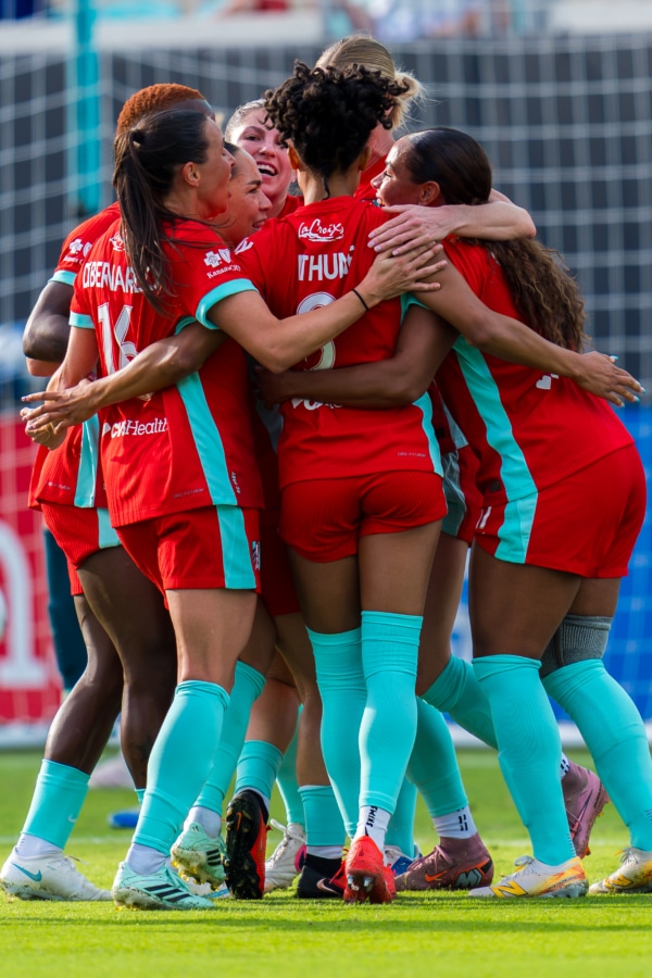 Team celebrating goal vs Washington Spirit.