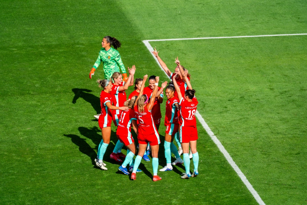 Photo of players celebrating a goal.