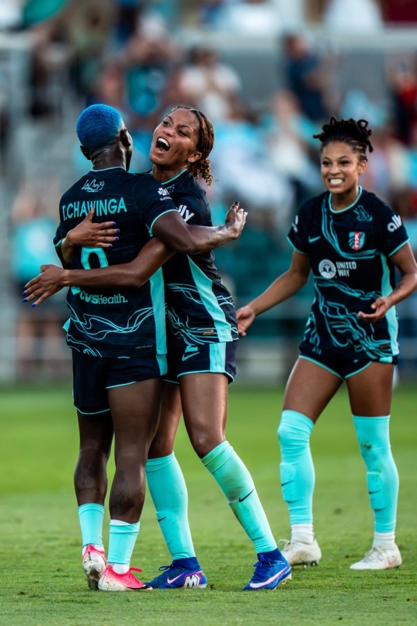 Temwa Chawinga, Laney Rouse, and Croix Bethune celebrating after a goal.
