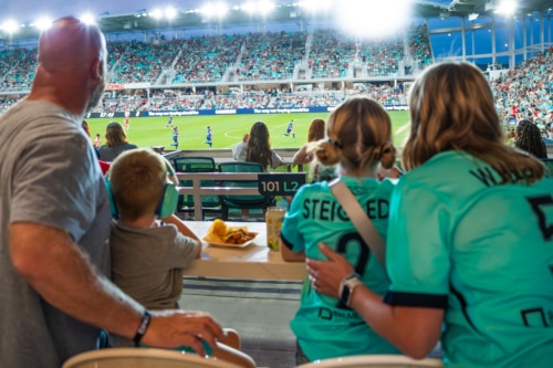 Family enjoying west sideline club seats on KC Current game day.