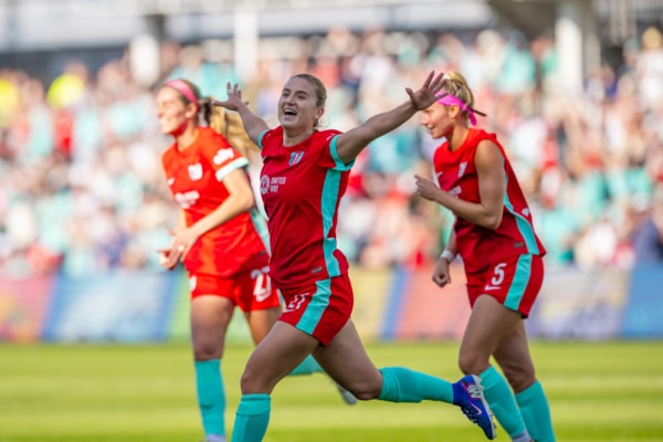 Photo of players celebrating a goal.