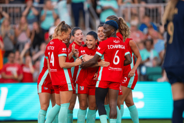 Claire, Izzy, Debinha, Rocky, and Temwa are celebrating.