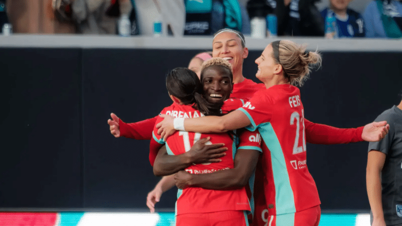 DiBernardo, Bia, Chawinga, and Feist are celebrating a goal.