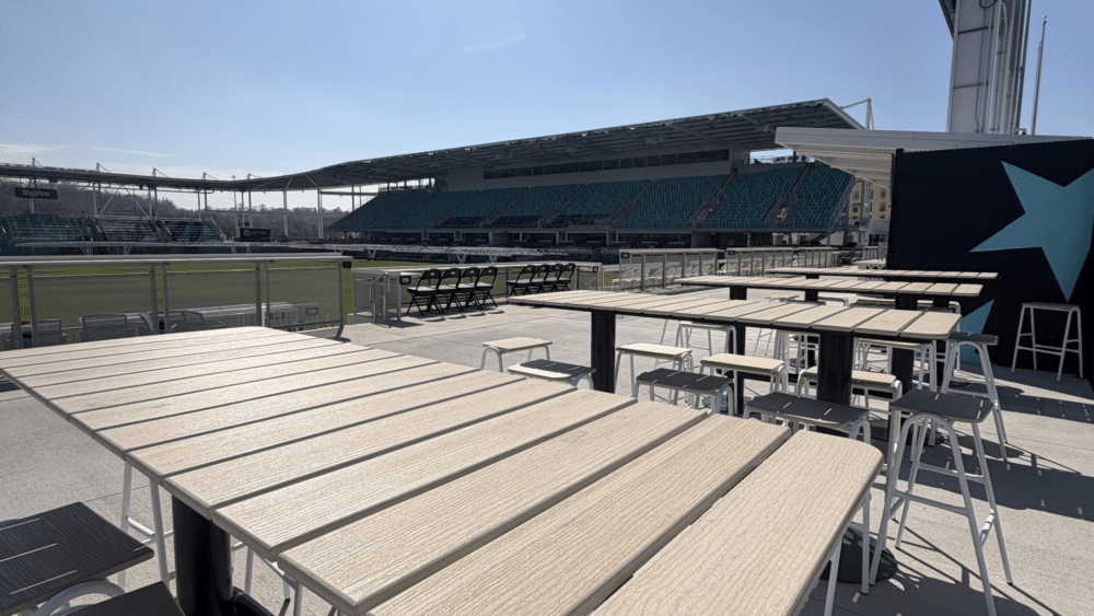 Hight top tables on north goal side.