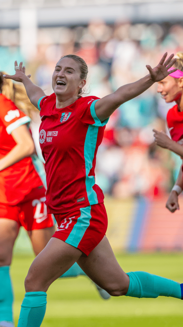 Photo of players celebrating a goal.