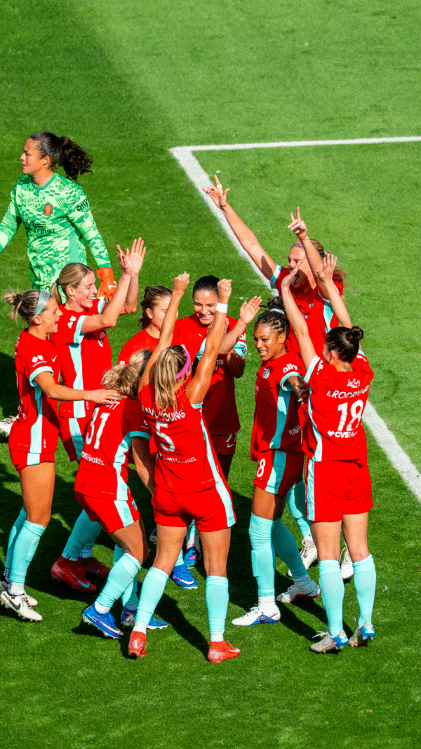 Photo of players celebrating a goal.