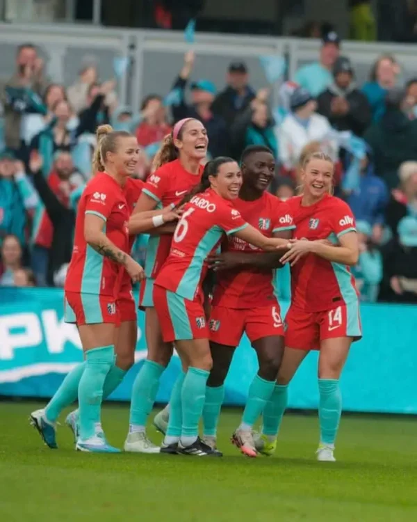 Mace, Sharples, DiBernardo, Chawinga, and Claire are celebrating a goal.